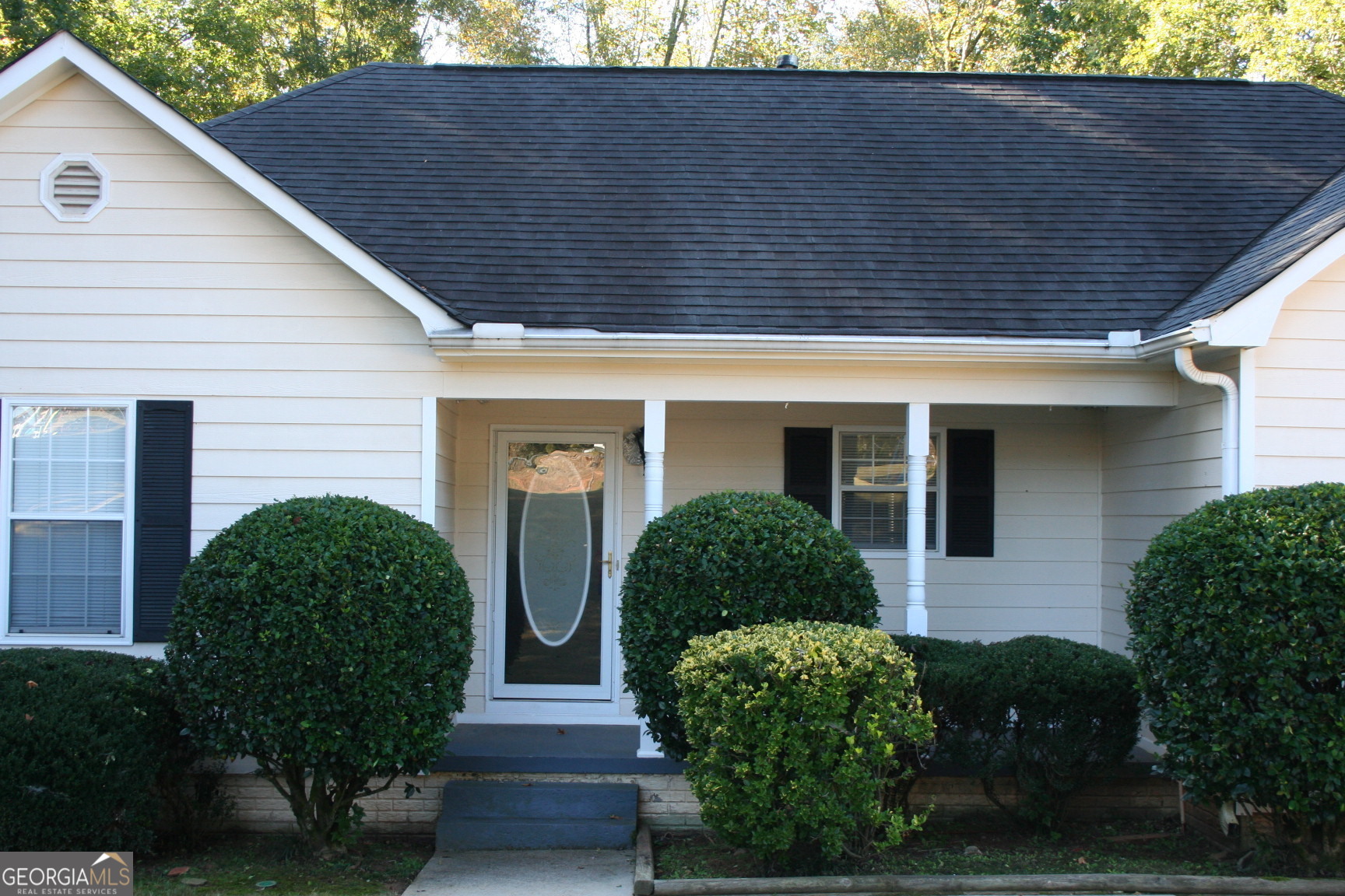 a front view of a house with garden