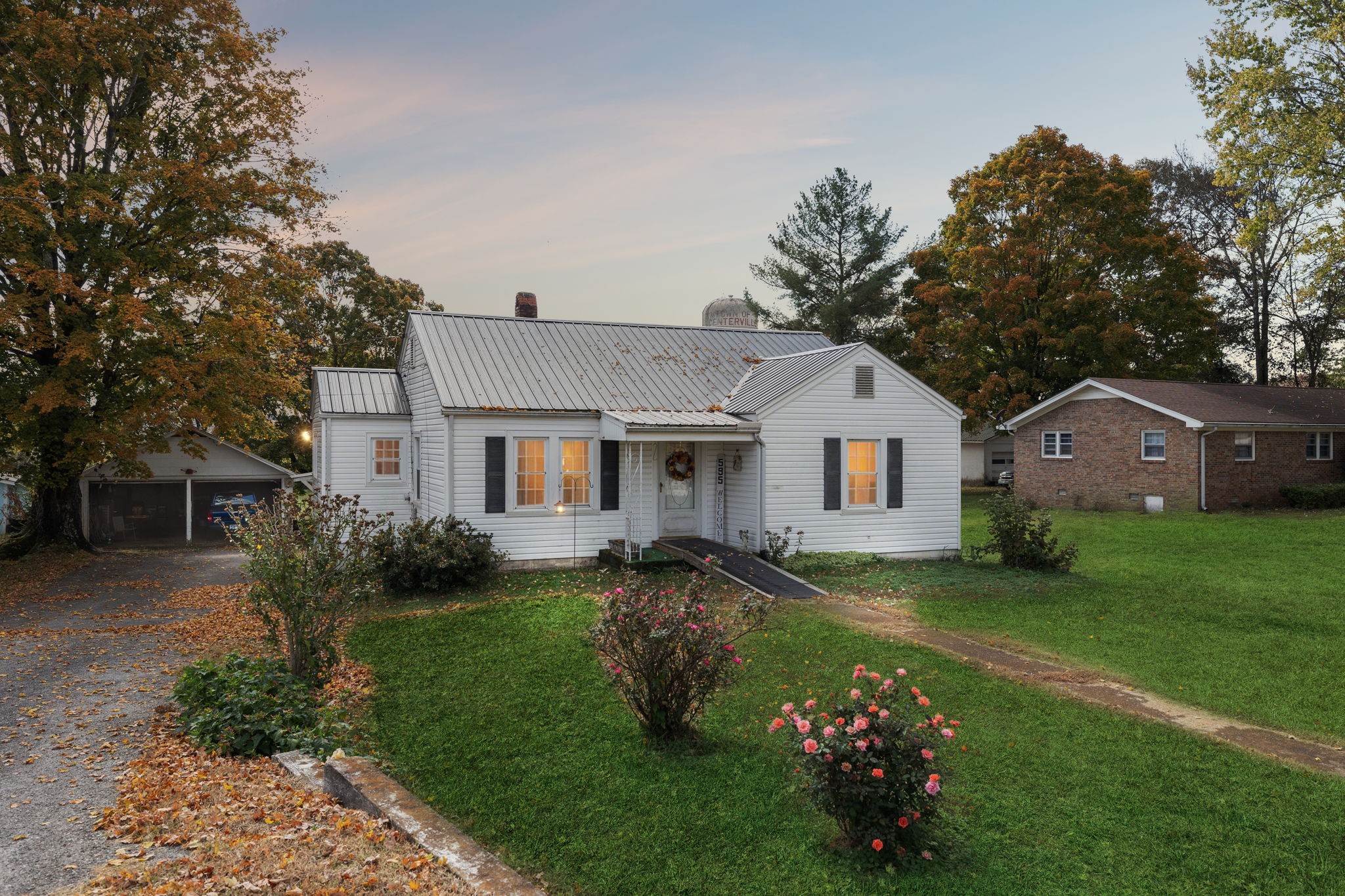 a front view of house with yard and green space