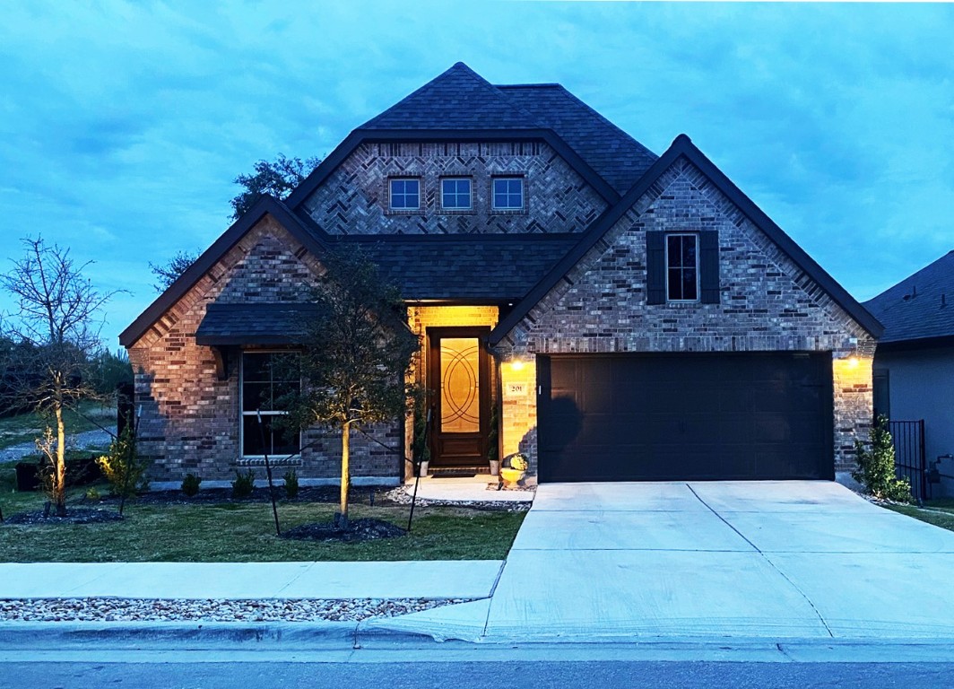 a front view of a house with garden