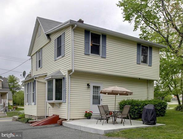 a front view of house with yard and outdoor seating