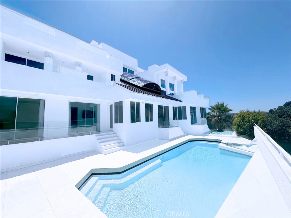 a view of a house with swimming pool and porch