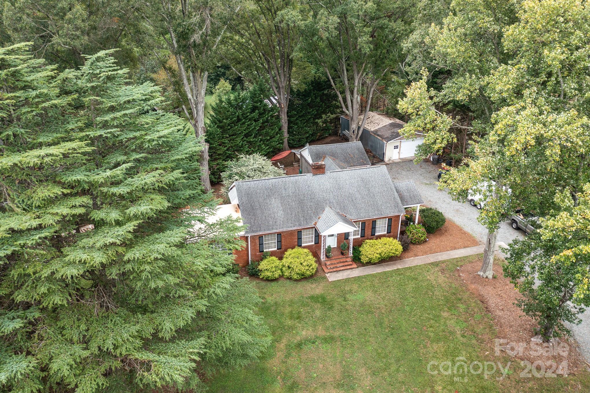 an aerial view of a house with swimming pool and big yard