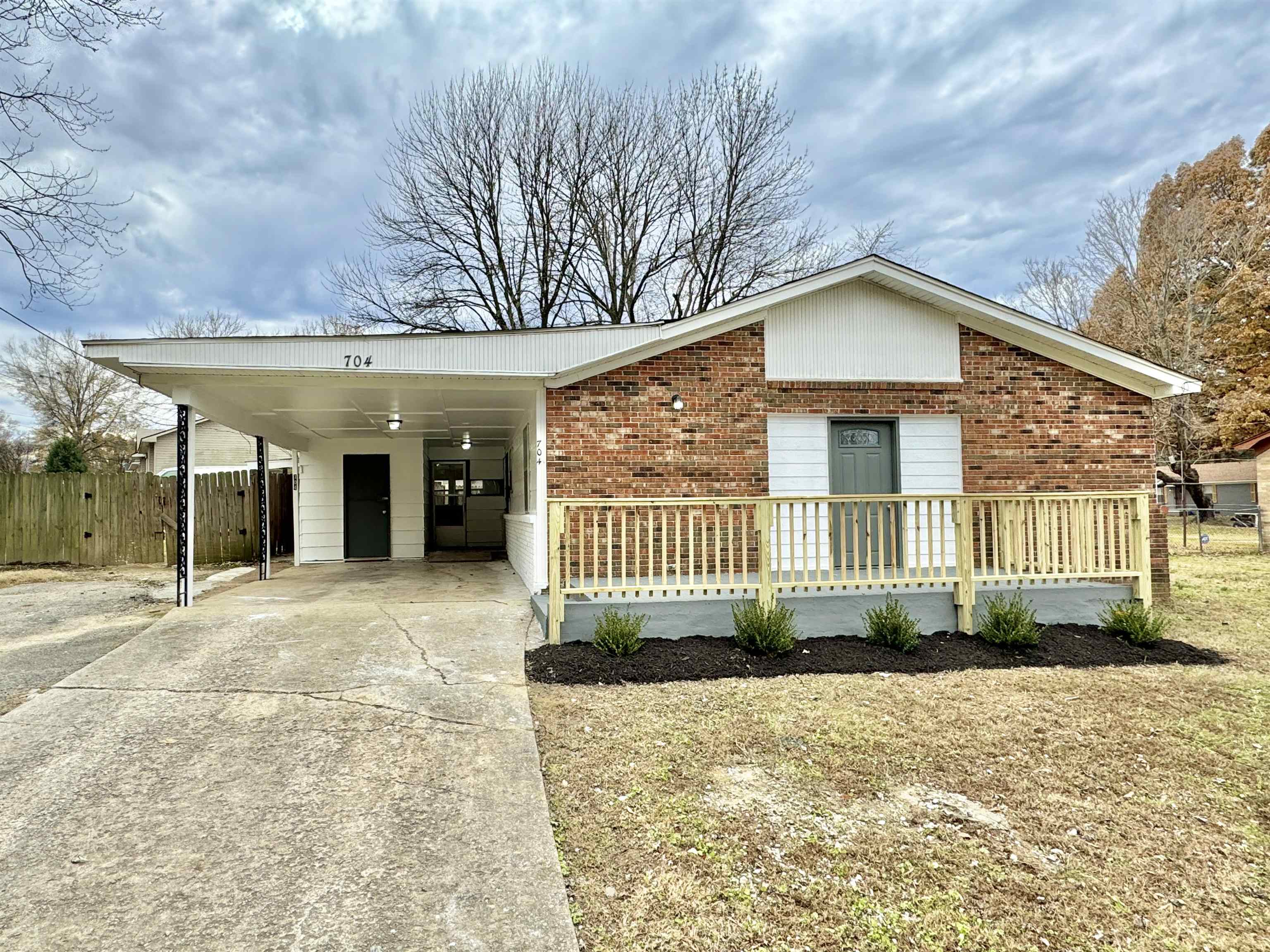 View of front of house with a carport