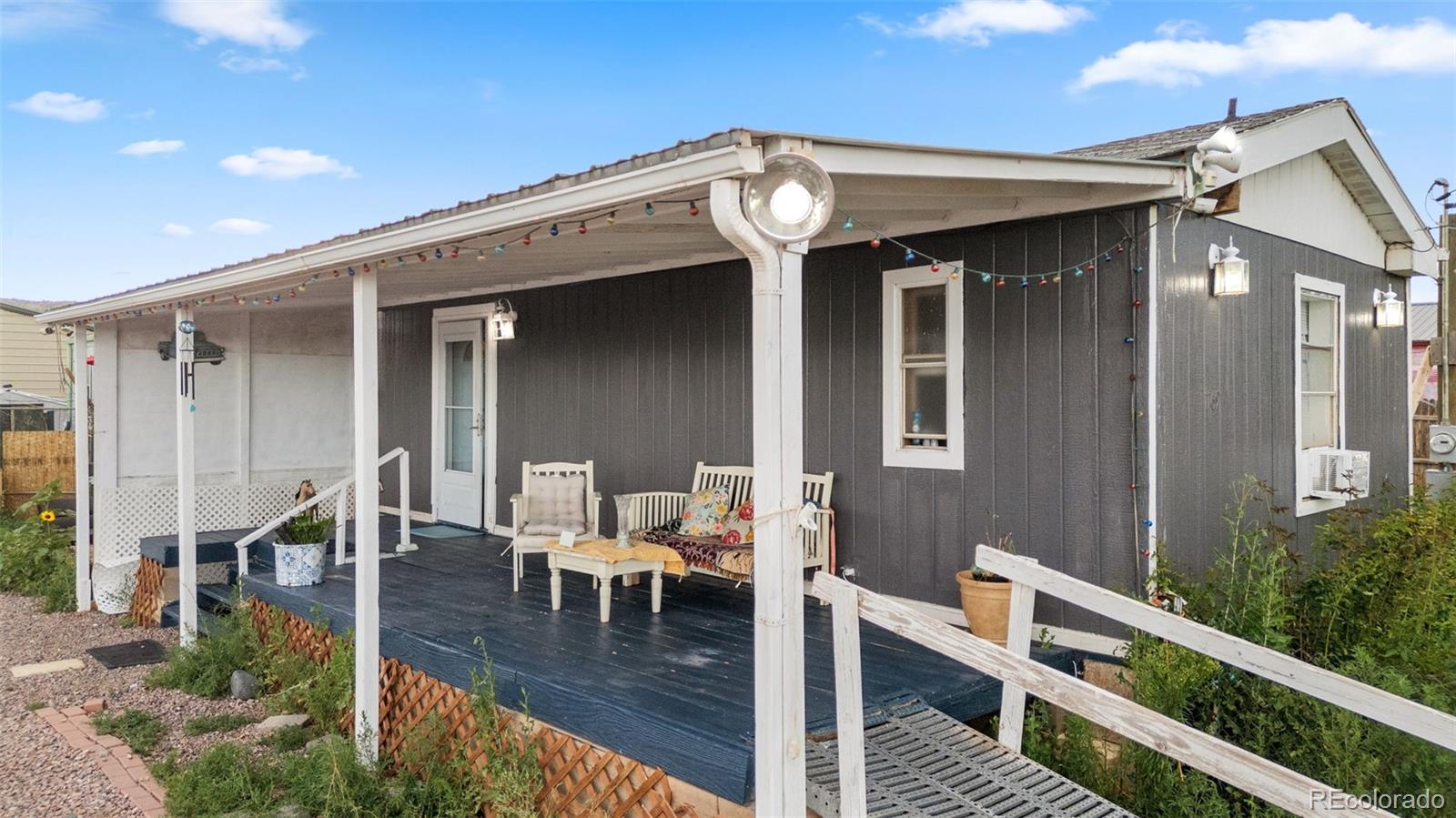 a front view of a house with outdoor seating