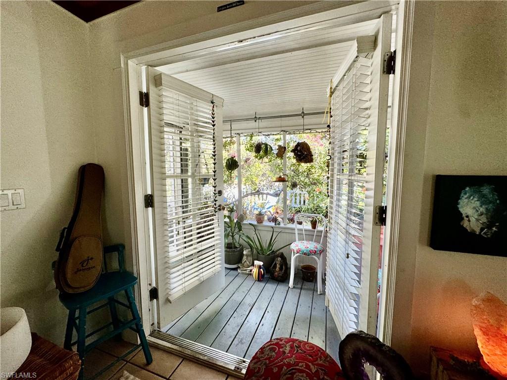 a view of a balcony with furniture and wooden floor