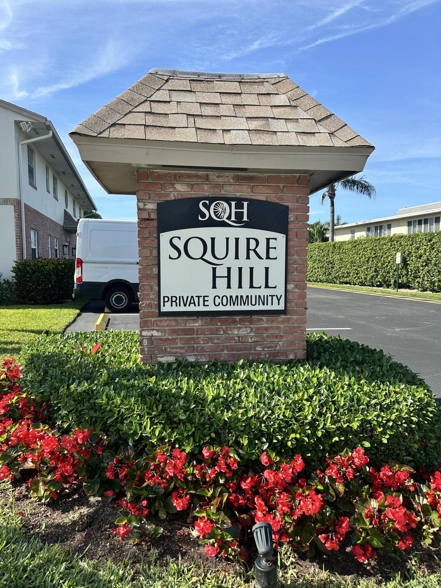 a view of sign board with buildings in the background