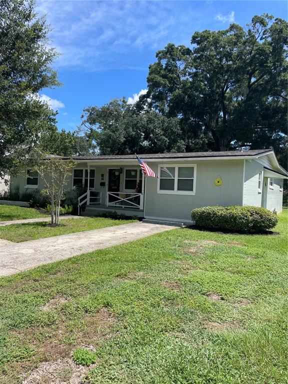 a view of house with a yard