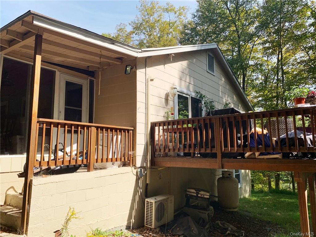 a view of wooden house with a yard