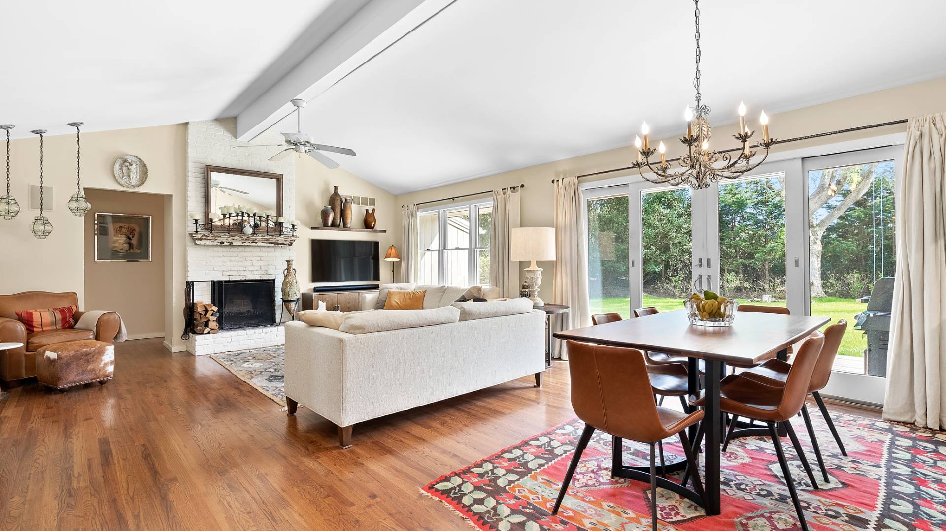 a living room with furniture a fireplace and a chandelier