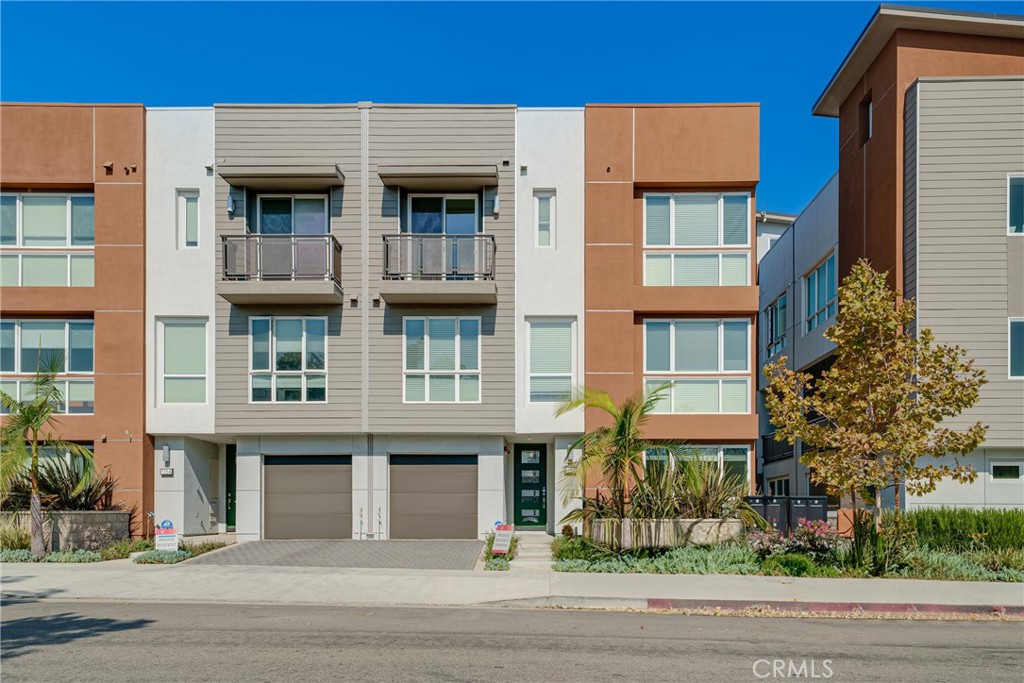 a front view of a residential apartment building with a yard