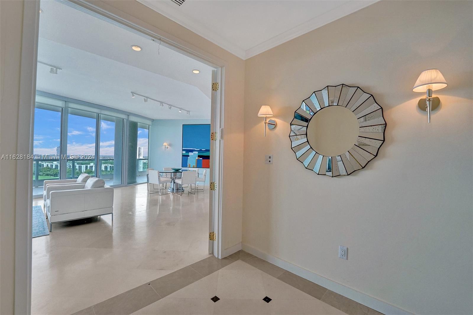 an entryway with wooden floor and a view of living room