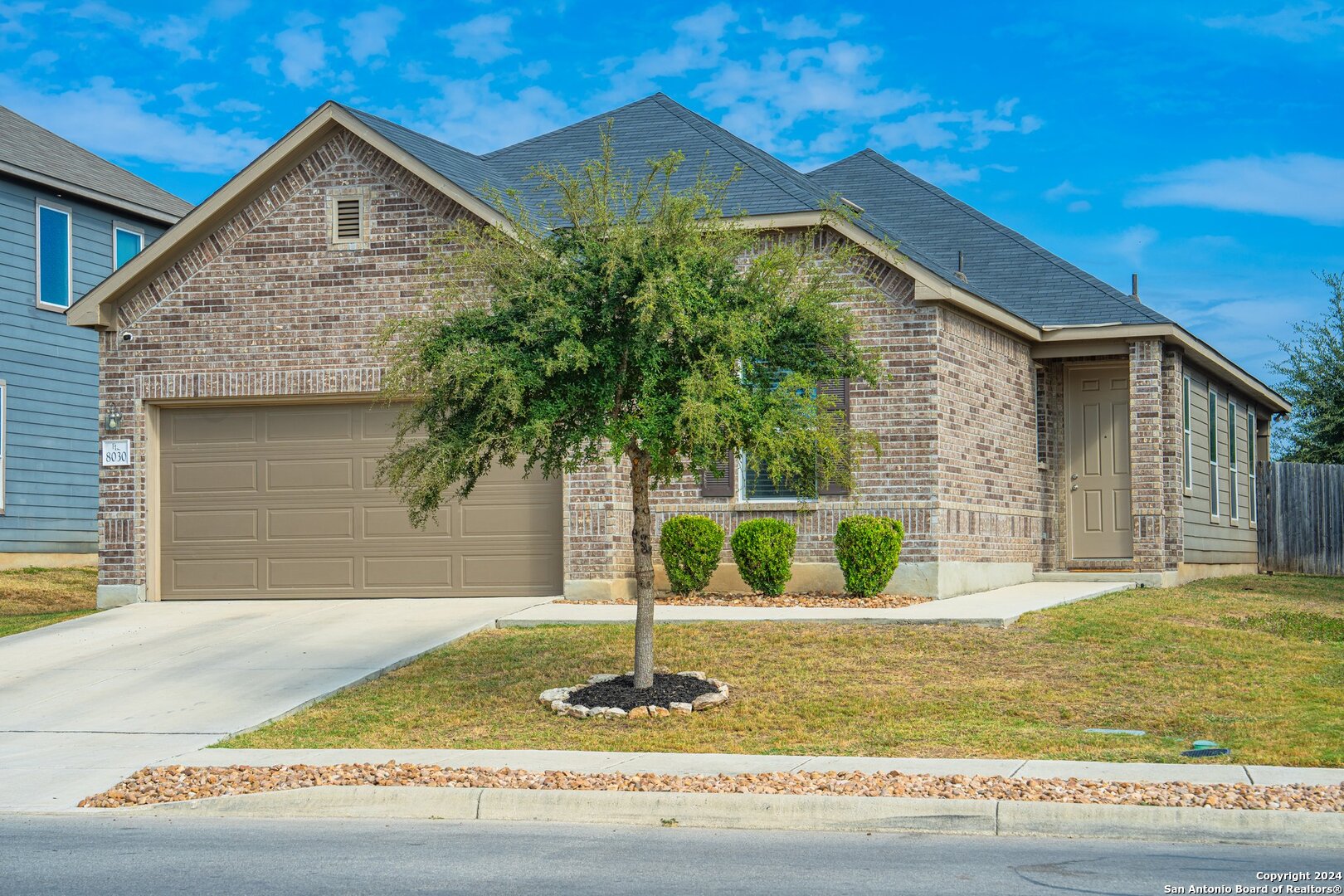 a front view of a house with garden