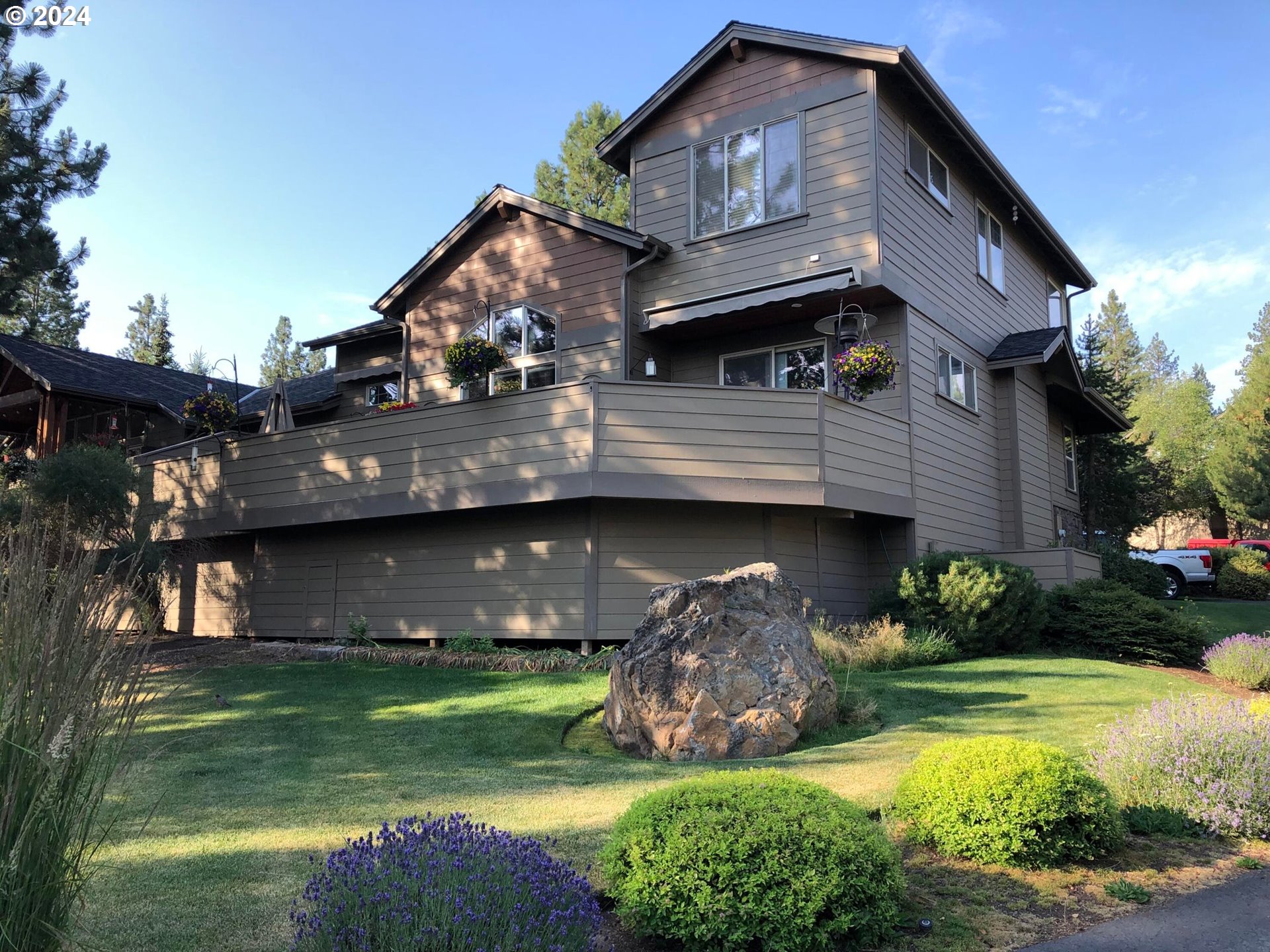 a view of house with garden space and swimming pool