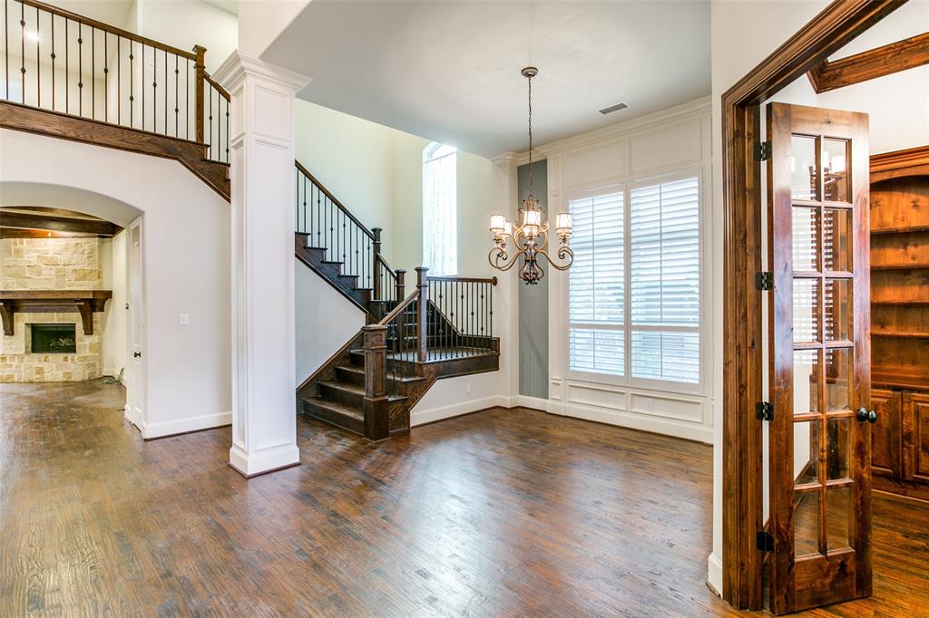 a view of an entryway with wooden floor and door