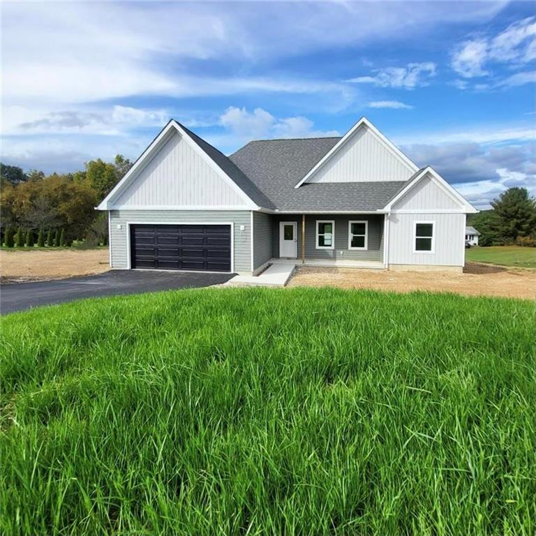 a front view of house with a garden