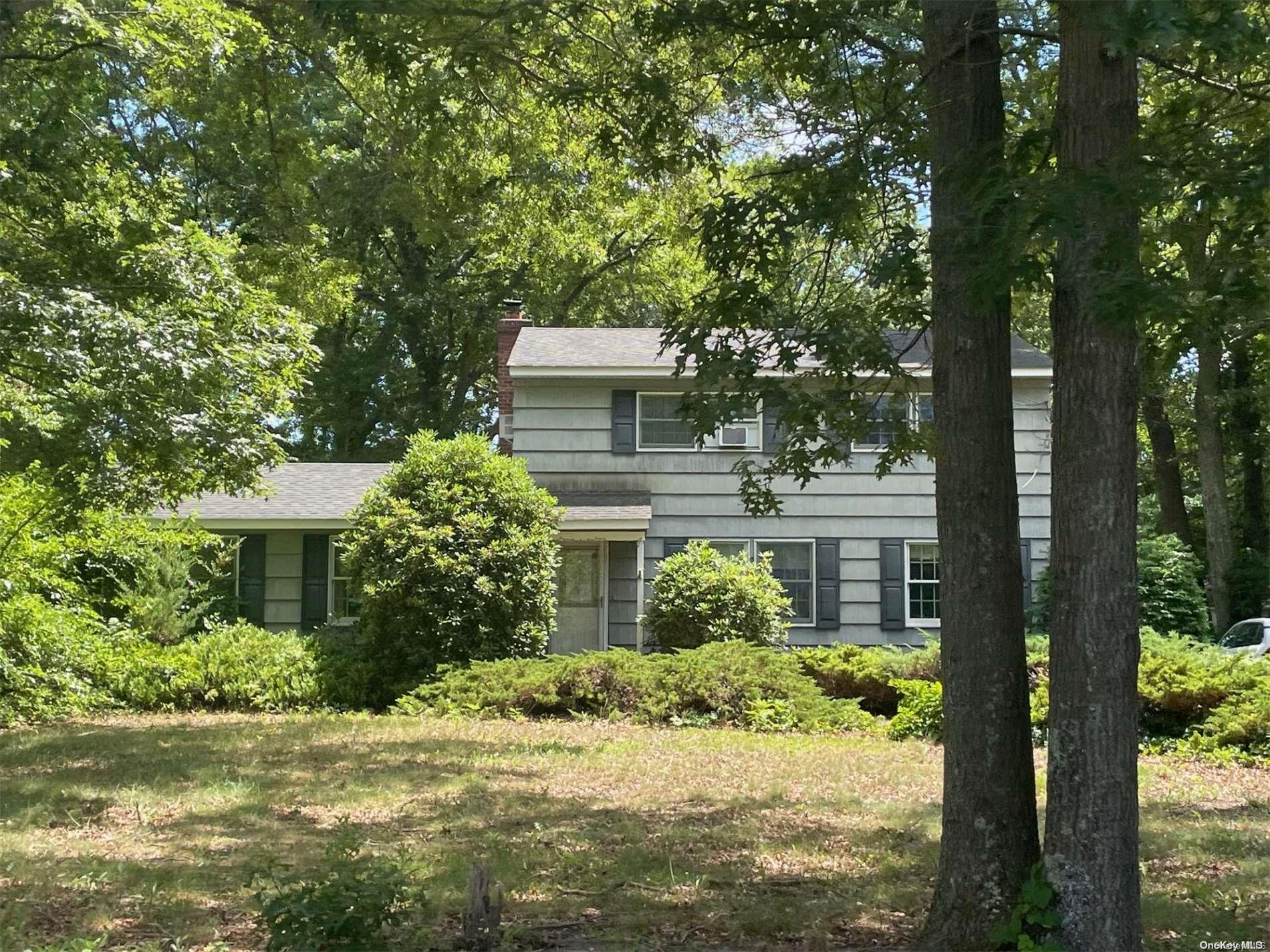 a front view of a house with a yard garage and outdoor seating