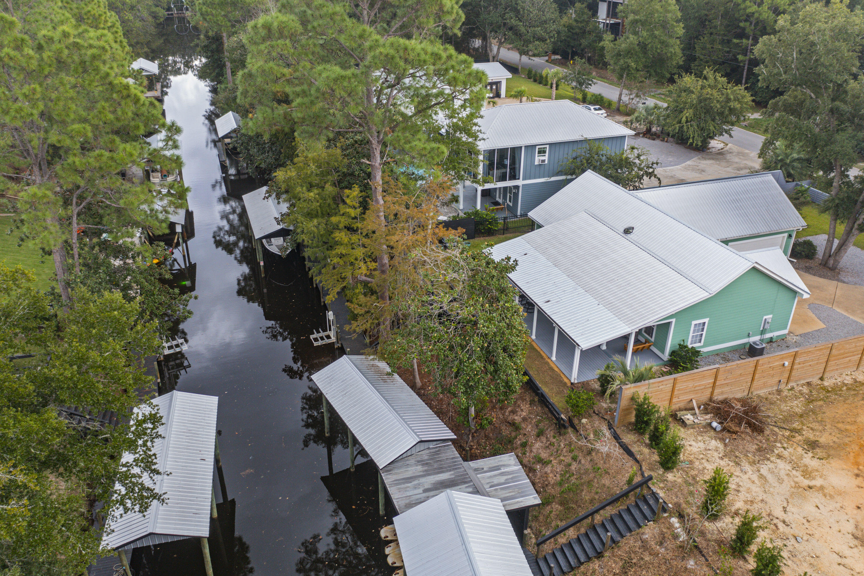 an aerial view of a house with a yard large trees