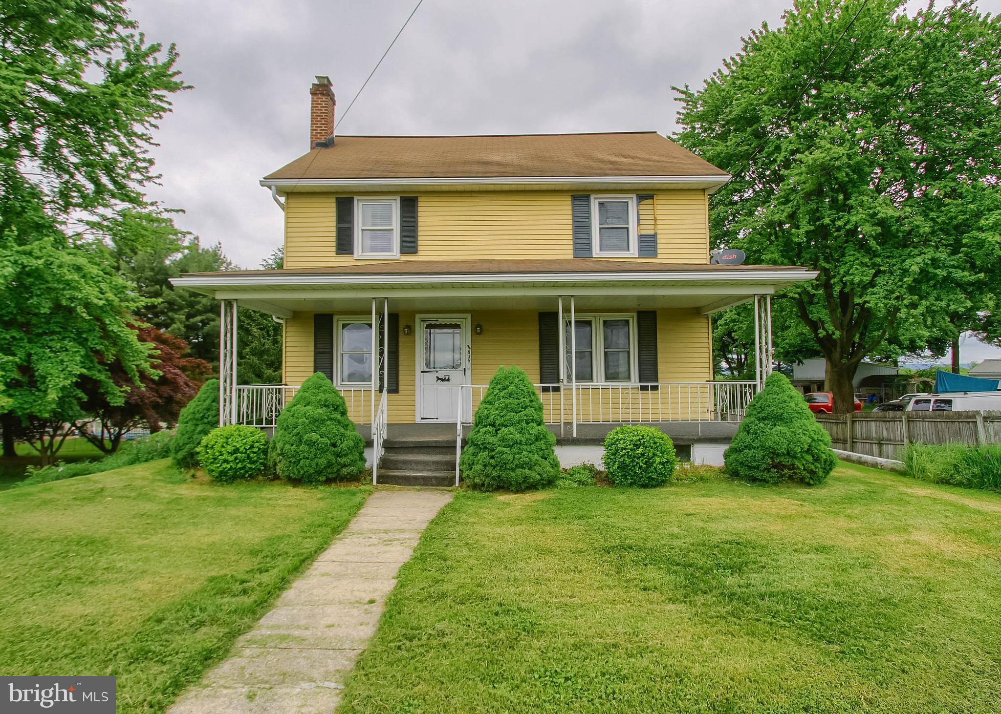 a front view of a house with garden and porch