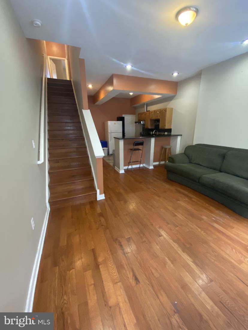 a living room with furniture and kitchen view