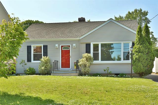 a front view of house with a garden