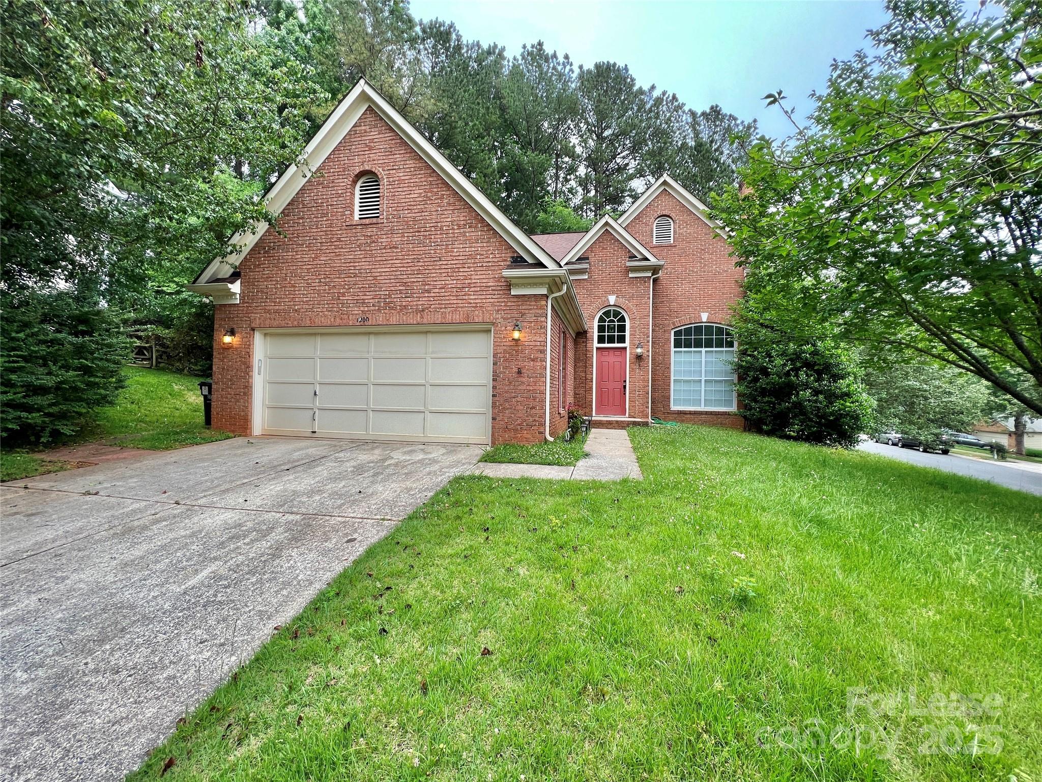 a front view of house with yard and green space