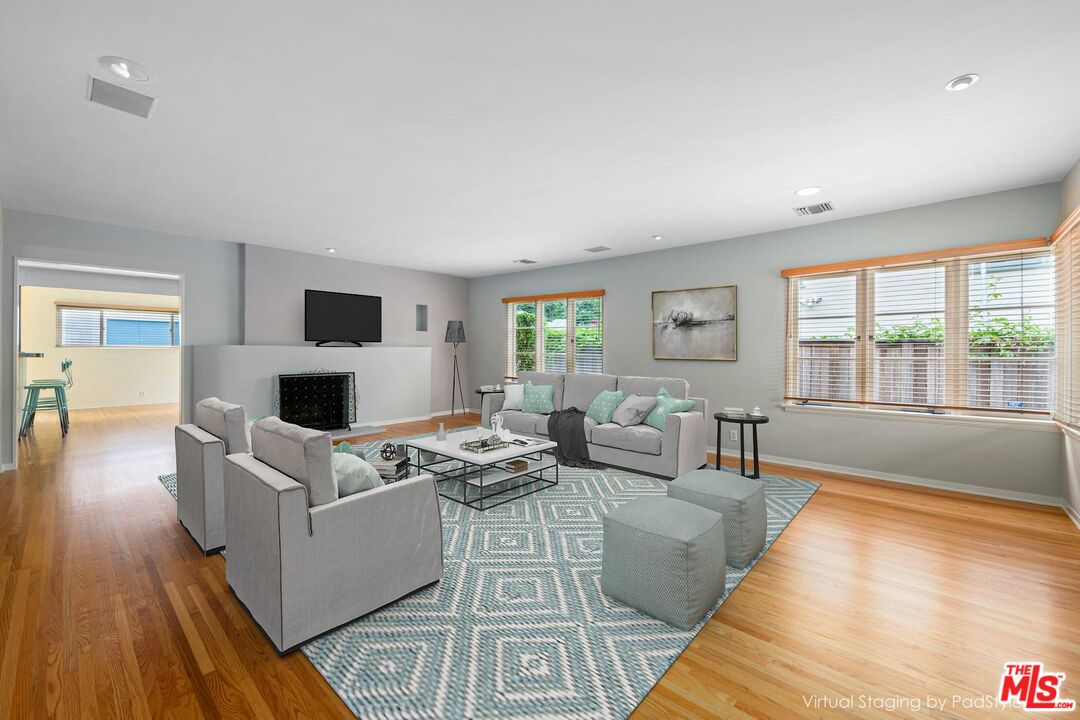 a living room with fireplace furniture and a wooden floor