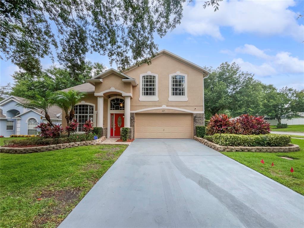 a front view of a house with a yard and garage