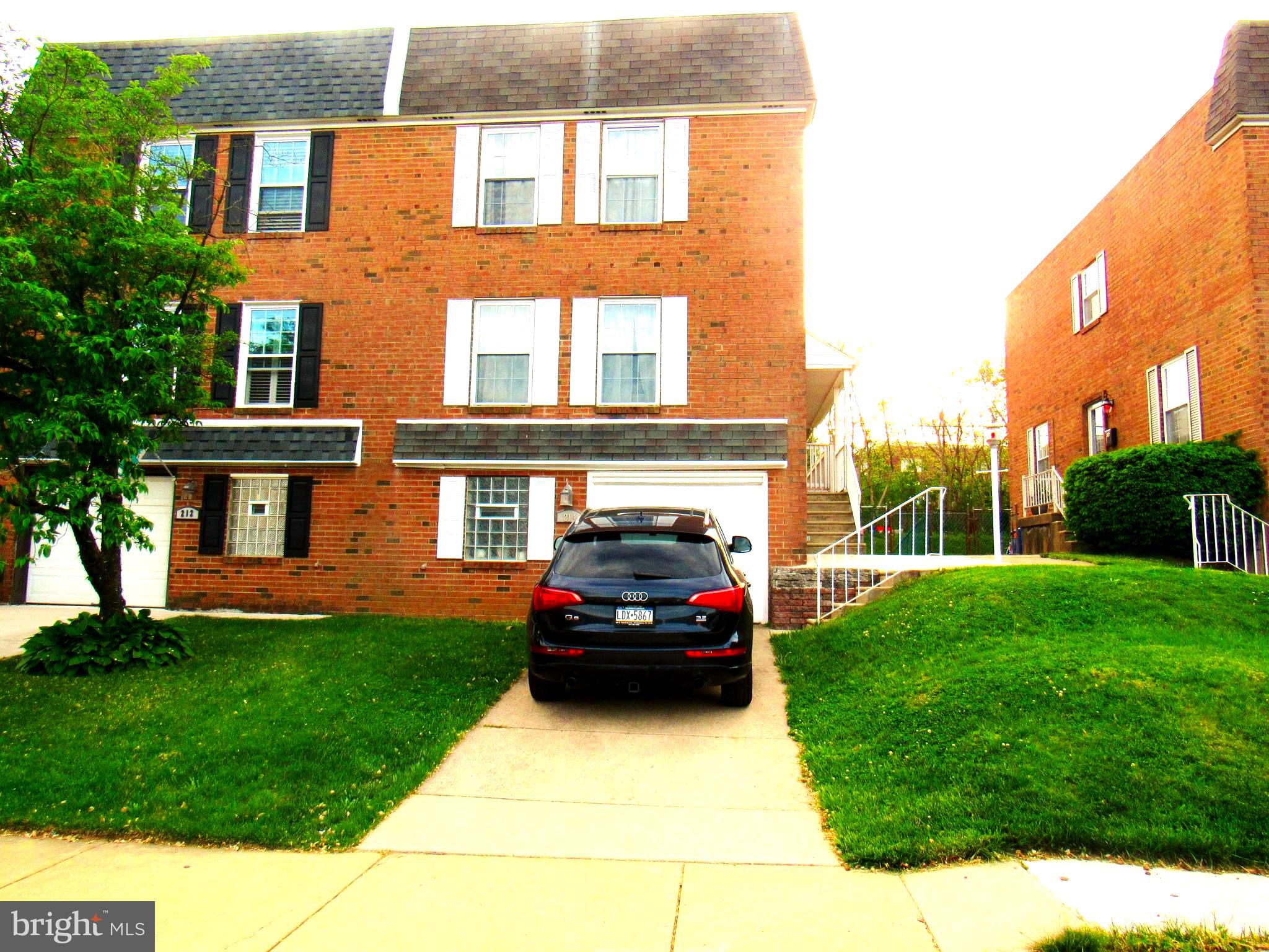 a car parked in front of a brick house