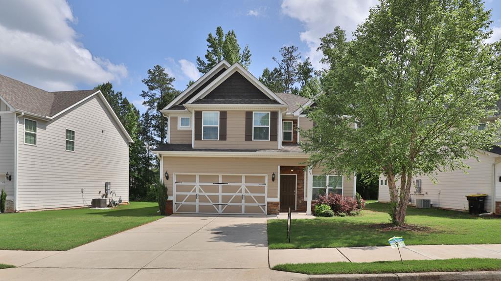 a front view of a house with a yard