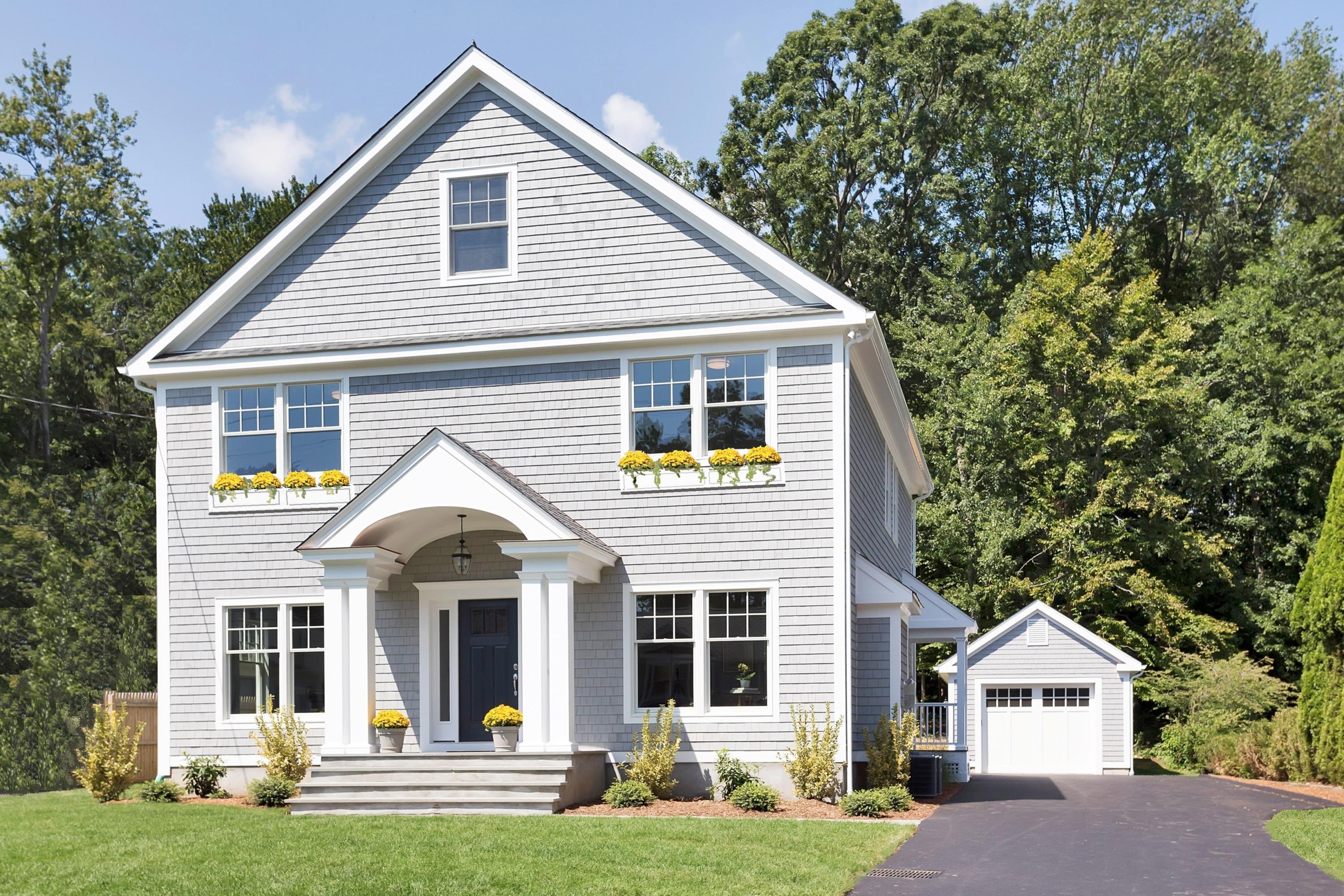 a view of house with yard and green space