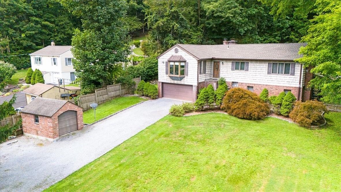 a aerial view of a house with swimming pool next to a big yard