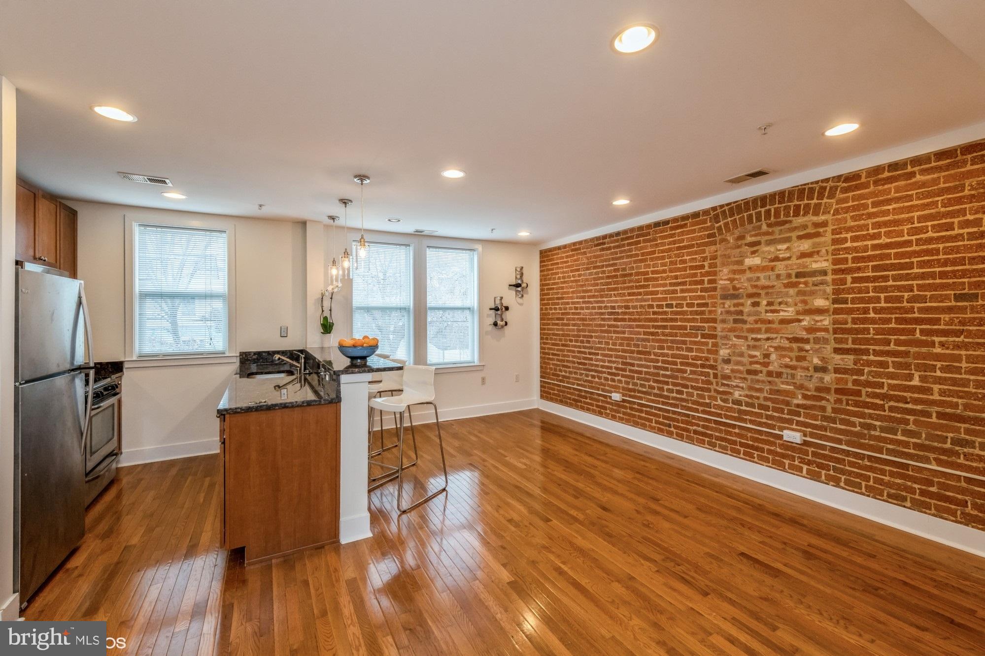 a view of a living room with furniture and wooden floor