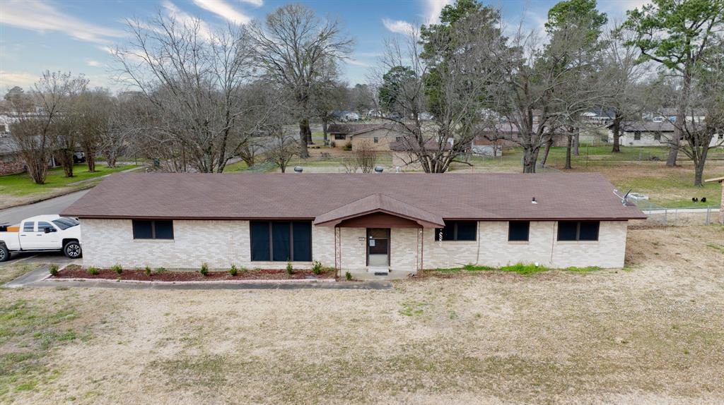 a house that has a tree in front of it