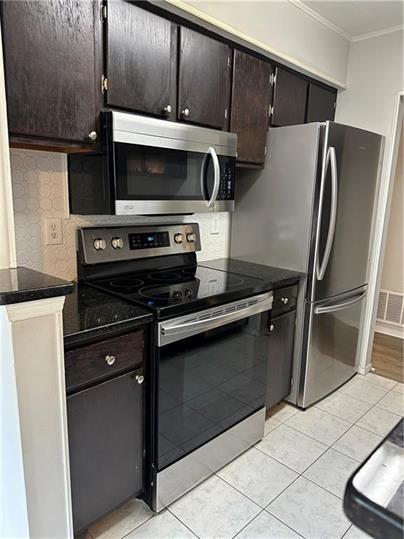 a kitchen with granite countertop a refrigerator and a stove