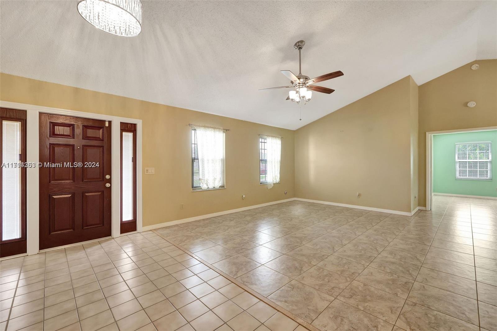 a view of an empty room with window and cabinet