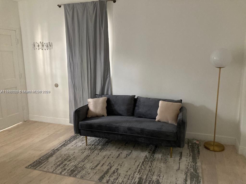 a living room with furniture and a rug