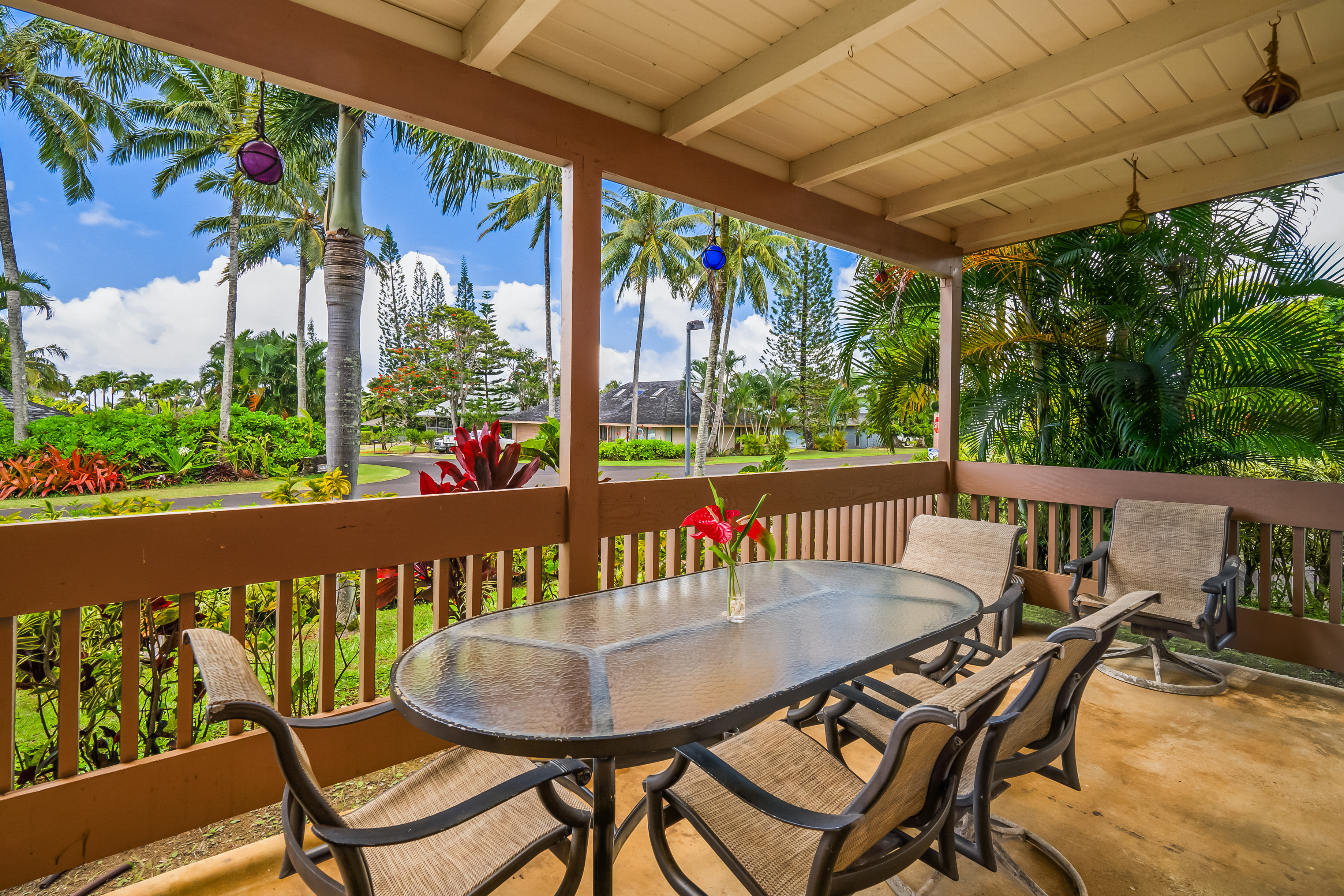 a view of a chairs and table in patio with a small yard