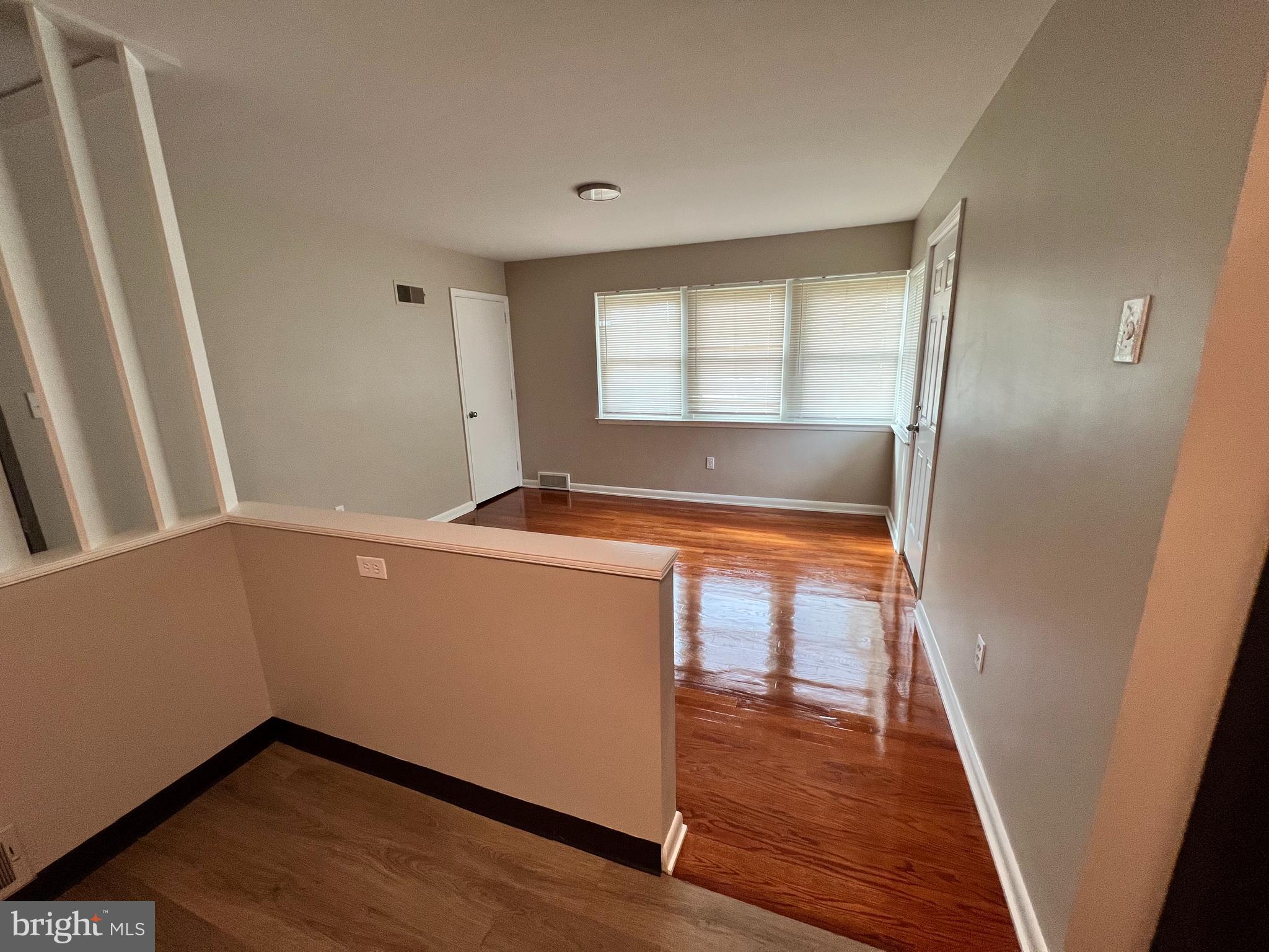 a room with wooden floor and a window