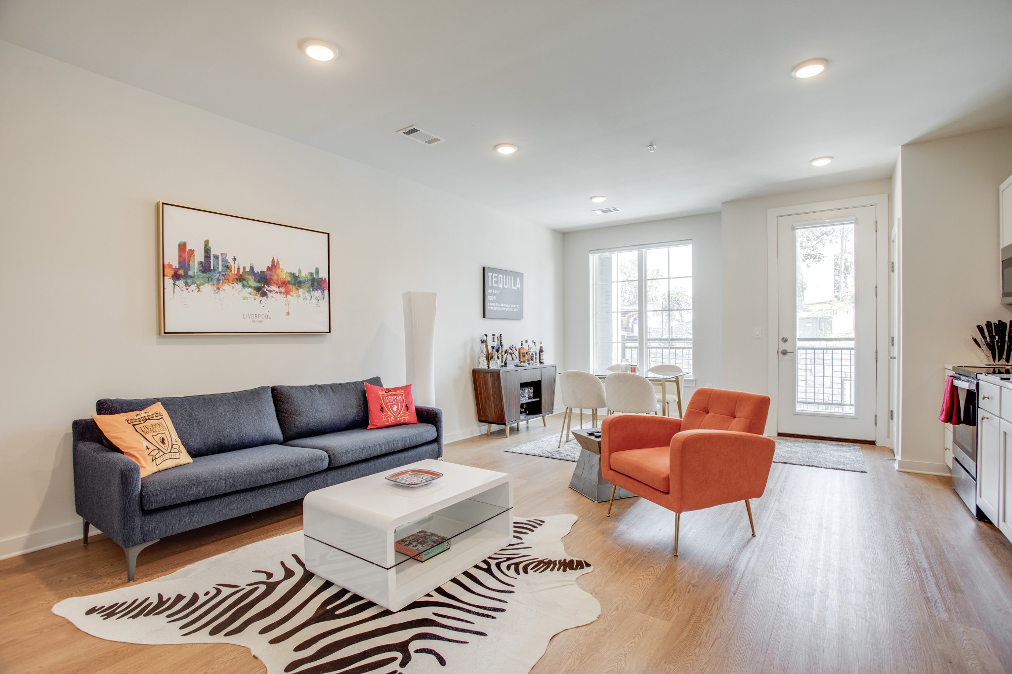 a living room with furniture and wooden floor