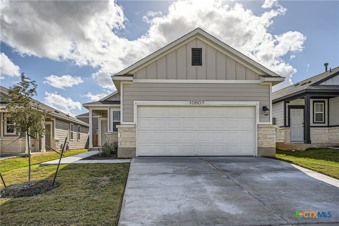 a front view of a house with a yard and garage