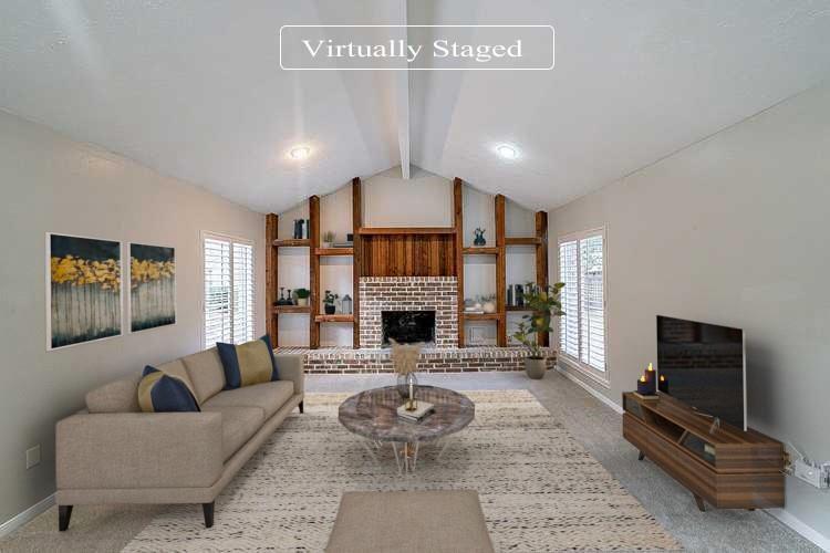 a living room with furniture a fireplace and a flat screen tv