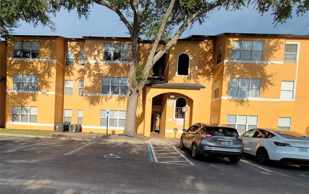 a view of building with car parked