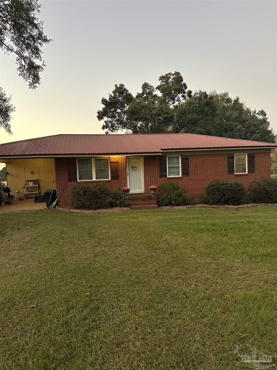 a front view of house with yard and green space