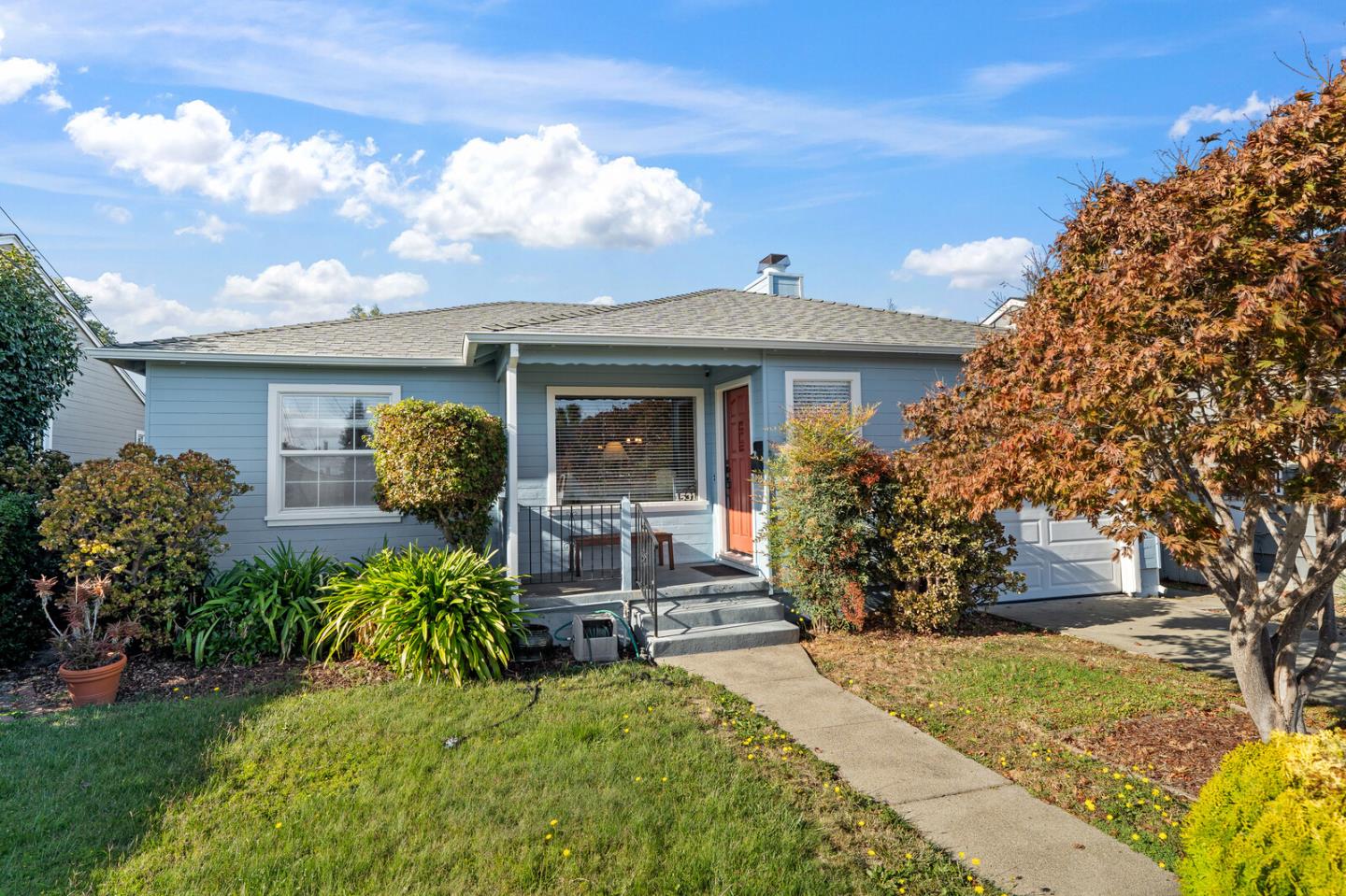 a front view of a house with garden