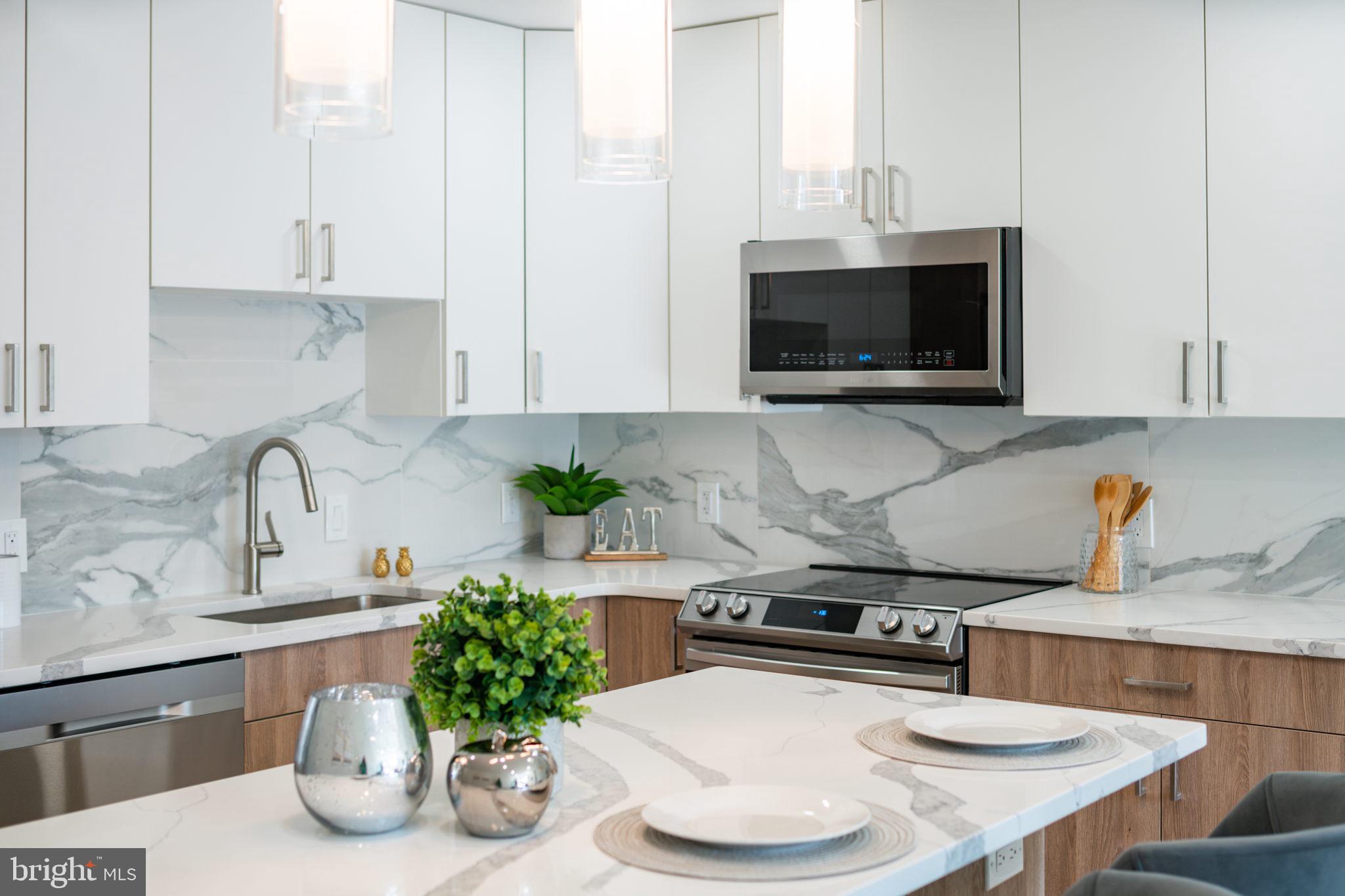 a kitchen with a microwave a stove and cabinets