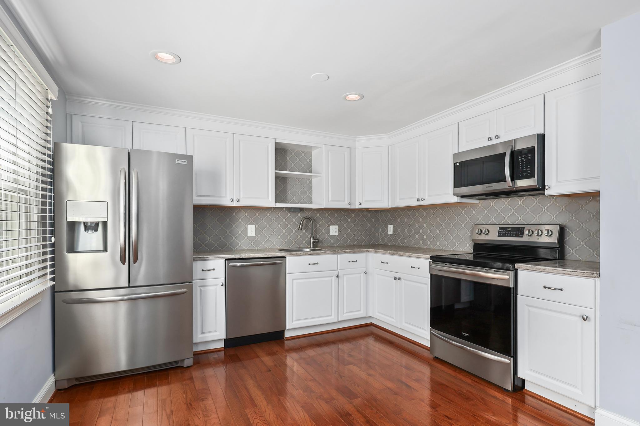 a kitchen with a refrigerator stove and microwave