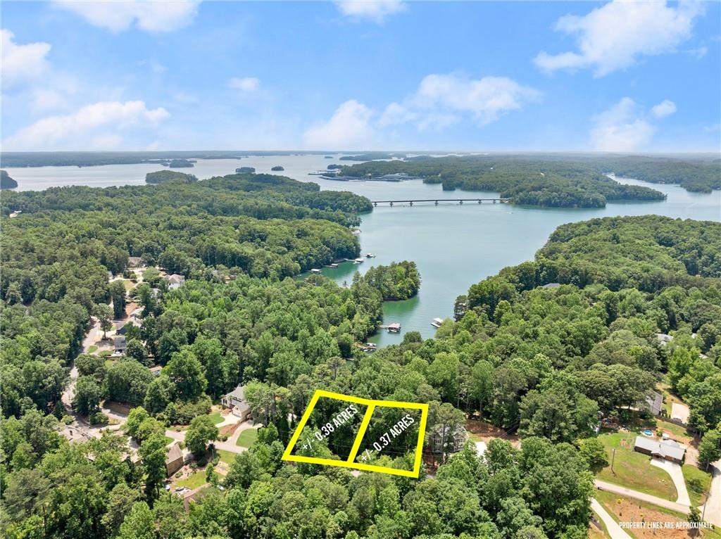 an aerial view of a house with a yard and lake view