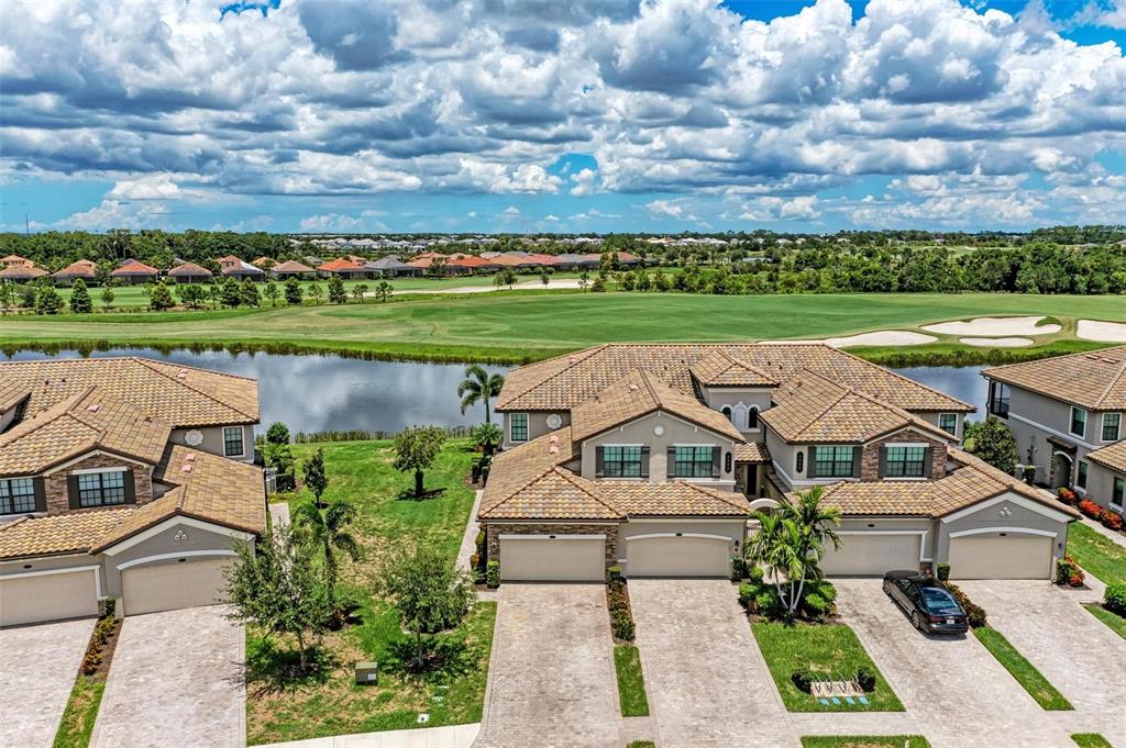 an aerial view of a house with a garden and lake view