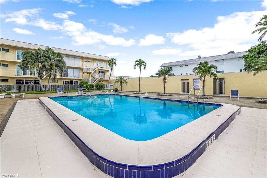 a view of swimming pool with outdoor seating