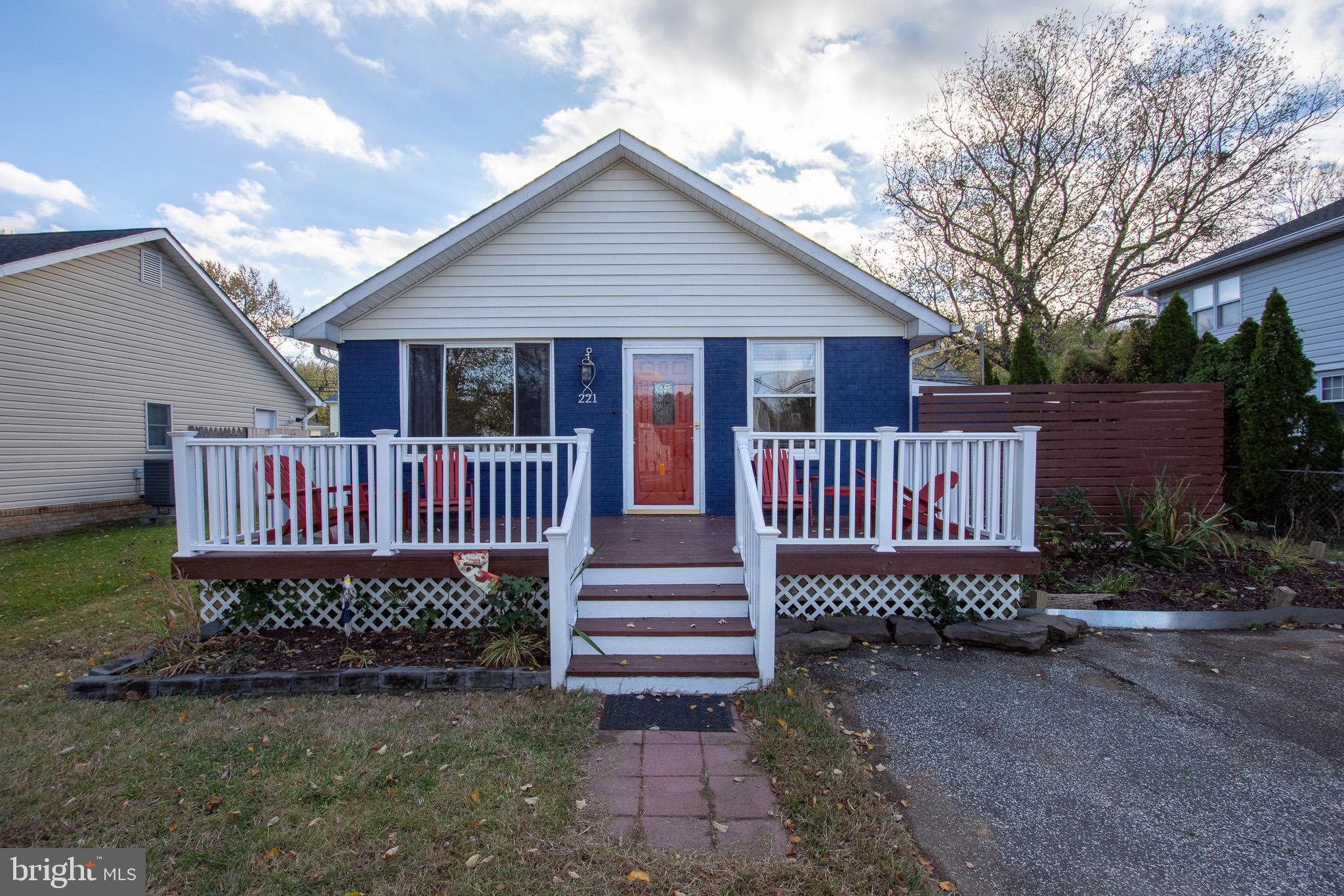 a view of a house with a deck and a yard